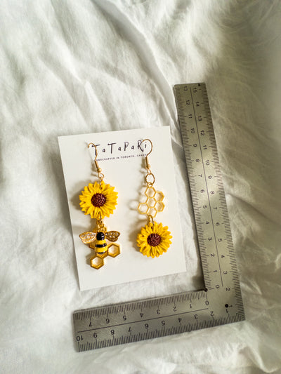 Asymmetrical sunflowers and bees